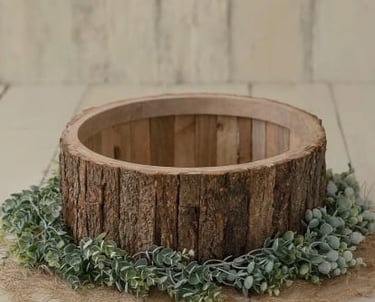 Rustic log wooden bowl prop for newborn photography with green leaves and burlap.